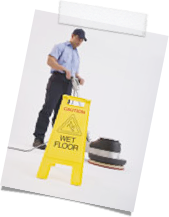 Cleaning Man using Floor polisher for Floor Maintenence and wet Floor sign.